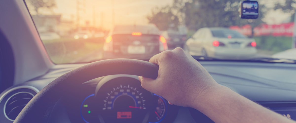 driver behind the steering wheel of a car