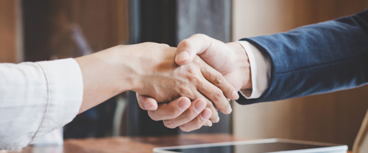 woman shaking hands after getting an unsecured loan