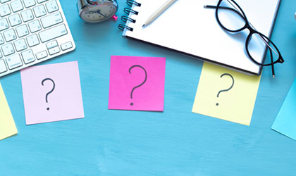 5 question mark sticky notes on desk