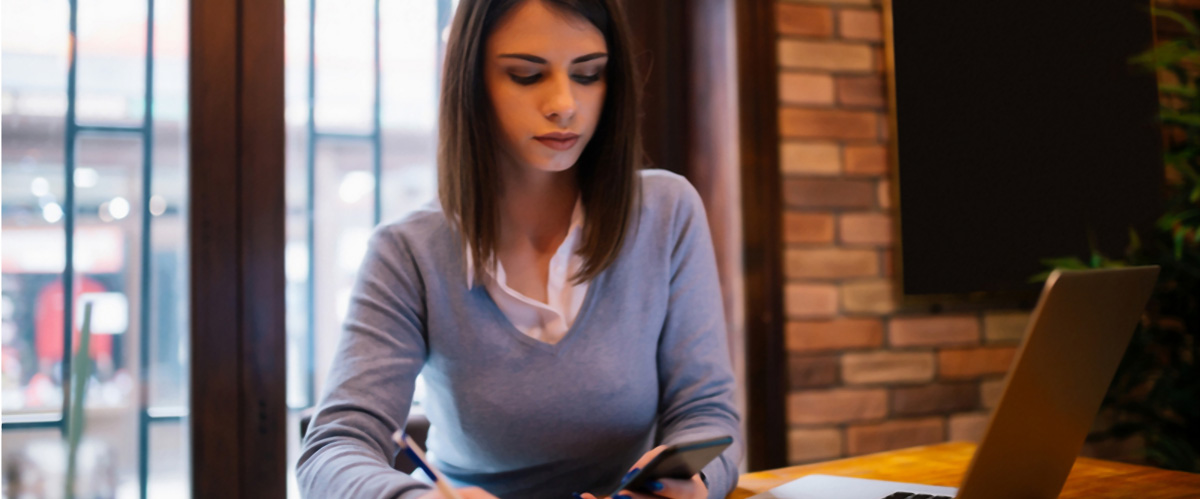 Woman writing short-term financial goals