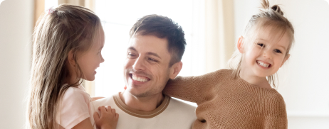 man smiling with his two children