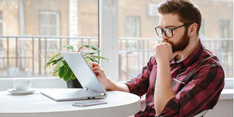 Man researching hard and soft credit checks online