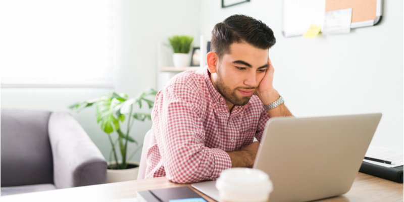 Worried man looking at his computer