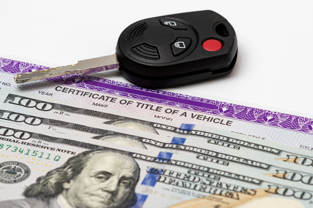 Car key, vehicle title, and 100-dollar bills cash.