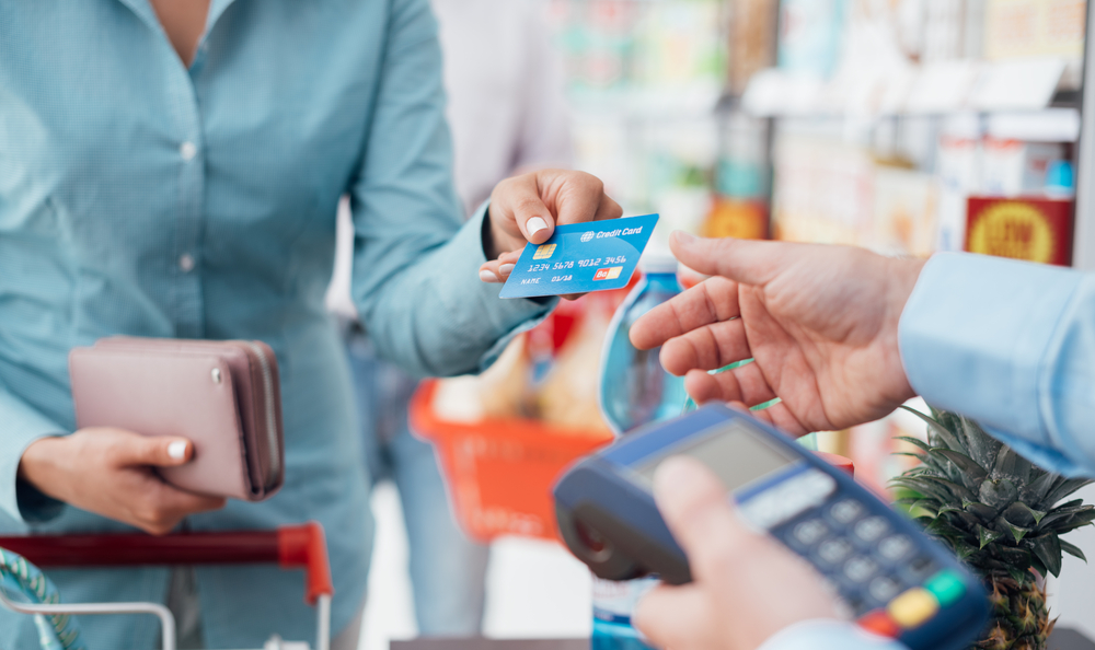 Shopper handing over credit card to pay for purchase