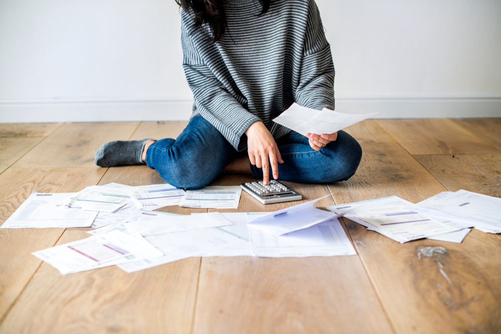 Women on floor managing debt.