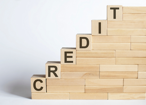 Wooden blocks built into stairs spelling the word CREDIT