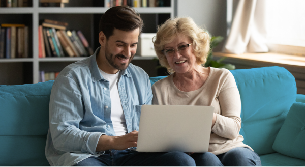 Grandmother and grandson looking at a laptop computer