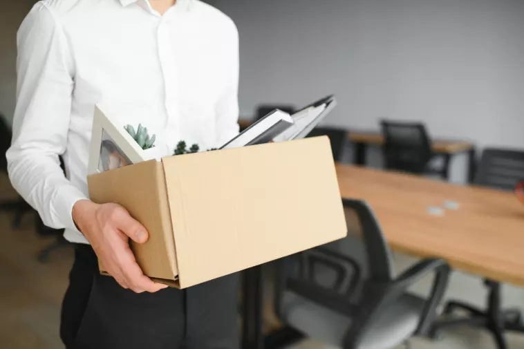 man holding box of belongings