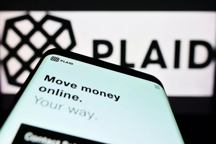 plaid inc behind a phone