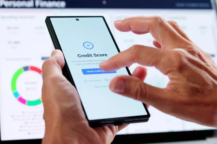 checking credit score on phone and laptop