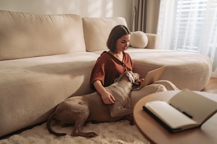 Woman sitting on floor with laptop