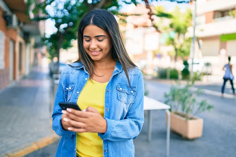 Girl using phone to track a money order