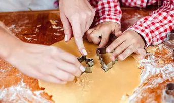 parent and child making cookies