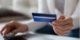 Woman holding a prepaid card