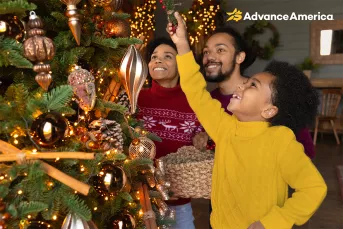 family decorating christmas tree