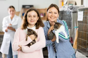 family holding shelter cats