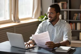 man looks at documents