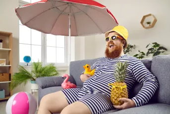 Man dressed for a vacation in his living room