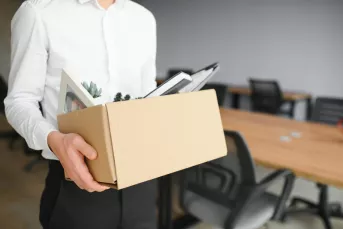 man holding box of belongings