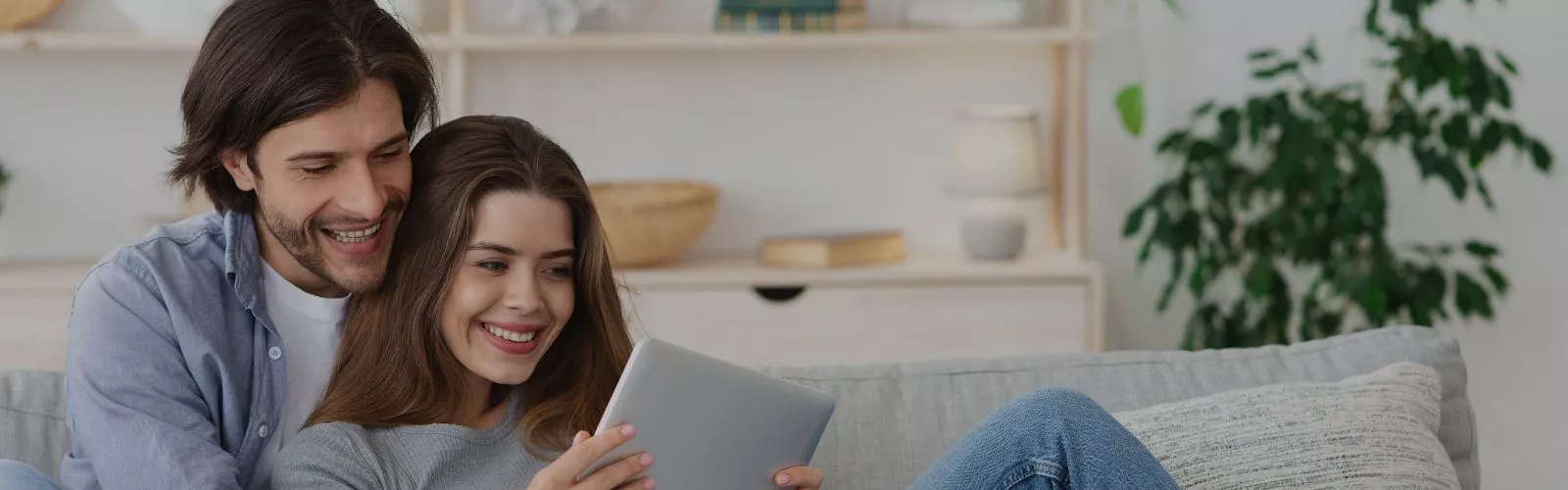 happy couple learning about advance america loans and services on an ipad