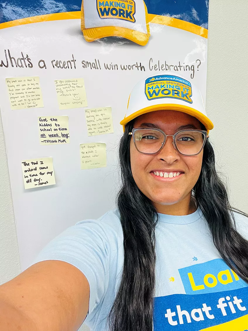 Woman takes a selfie in a "making it work" hat