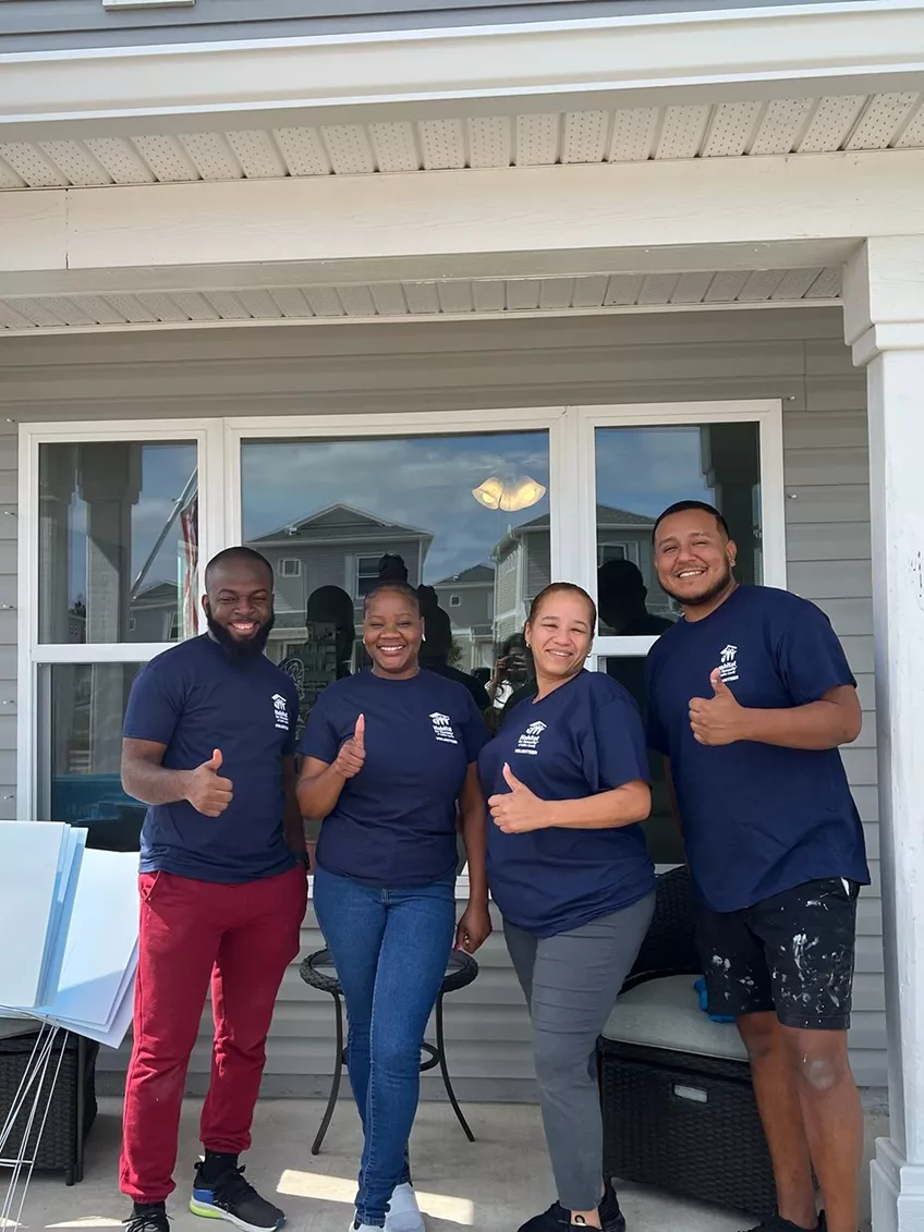 four people give thumbs up