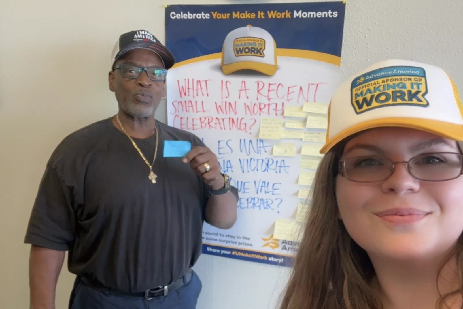 man holds post it note in front of "make it work" poster