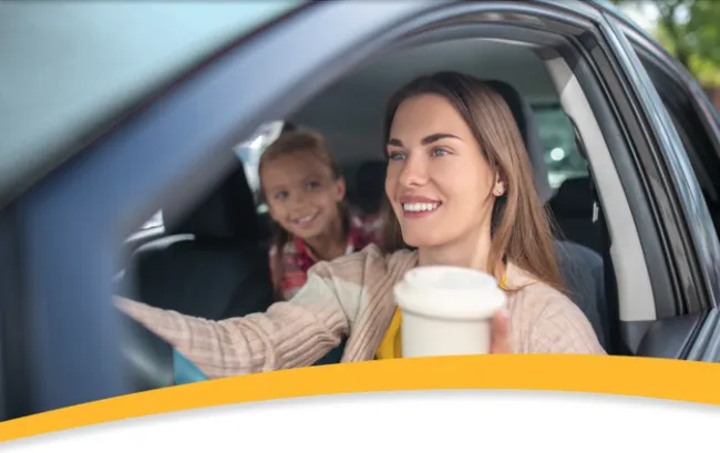 person driving car with child in back seat